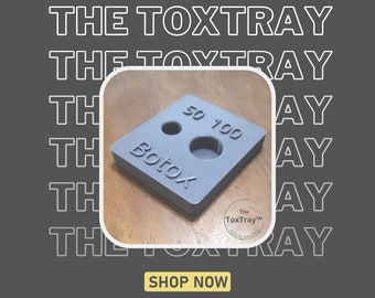 May include: Gray plastic tray with two circular cutouts labeled "50" and "100". The tray also has a larger cutout labeled "Botox". The tray is labeled "The ToxTray™ Patent Pending".