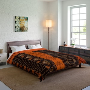 May include: A black and orange patterned duvet cover with a geometric design. The duvet cover is on a bed with white pillows and a brown wooden headboard.