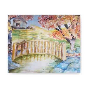 May include: A watercolor painting of a wooden bridge over a pond with a small wooden cabin in the background. The trees in the background have red and orange leaves, suggesting autumn.