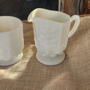 Westmoreland milk glass creamer and sugar bowl, in the Paneled Grape pattern.