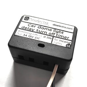 May include: Black car dome light delay turn off timer with Deselectra branding. The timer has a dimming effect with a range of 0-30 seconds. It is rated for 3 amps and 12 volts DC. The timer is designed for incandescent lights.
