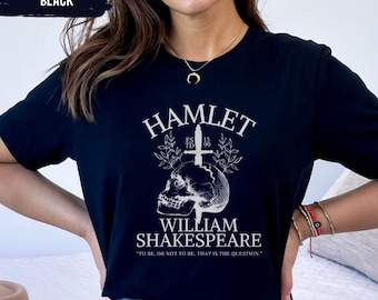 May include: Black t-shirt with a white graphic of a skull with a dagger through it. The graphic also includes the text "Hamlet", "ESTD 1599", "William Shakespeare", and "To be, or not to be, that is the question."