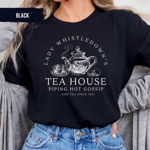 May include: Black t-shirt with a white graphic of a teapot, teacup, and macarons. The text reads "Lady Whistledown's Tea House Piping Hot Gossip... and tea since 1813."