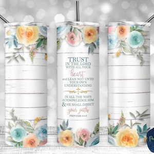 May include: A white tumbler with a floral design and a quote from Proverbs 3:5-6: "Trust in the Lord with all your heart and lean not unto your own understanding. In all your ways acknowledge Him & He shall direct your paths."