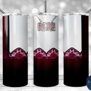 May include: A stainless steel tumbler with a white background and a red and black lace design. The tumbler has a silver charm with the words "Bite Me" on it.
