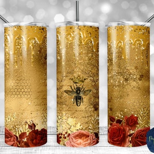 May include: Three gold glitter tumbler cups with a dripping honey design. The center cup features a black and gold bee with a crown. The cups have a red and gold floral design at the bottom.
