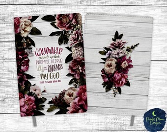 May include: A white journal with a floral design and the text "WAYMAKER miracle worker PROMISE KEEPER LIGHT IN THE DARKNESS MY GOD THAT IS WHO YOU ARE".