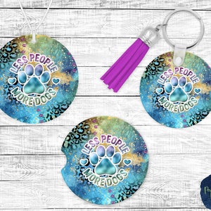 May include: Three round, blue and gold coasters with a paw print and the text "Less People More Dogs".