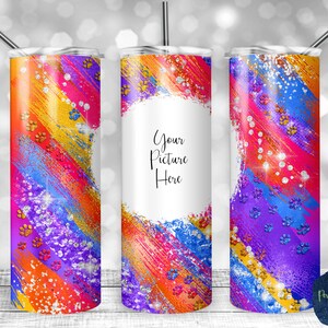 May include: Three colorful stainless steel tumblers with a rainbow paint splatter design and glitter accents. The center tumbler has a white circle with the text "Your Picture Here".