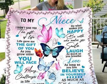May include: A pink and white blanket with a butterfly design and the text "To My Niece." The blanket features various butterflies in shades of pink, blue, and orange, with inspirational text.