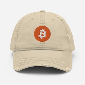 May include: A beige distressed baseball cap with an orange embroidered Bitcoin logo.