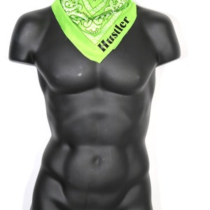 May include: A green bandana with a white paisley pattern and the word "Hustler" printed in black.