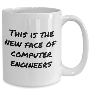 May include: White ceramic coffee mug with black text that reads "This is the new face of computer engineers".
