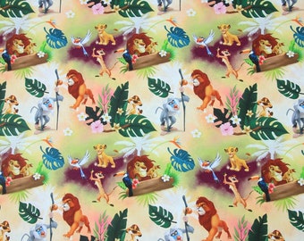 May include: A colourful fabric with a repeating pattern of cartoon lions, monkeys, birds, and other jungle animals. The background is a light yellow with green leaves and pink flowers.
