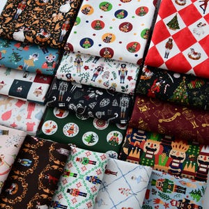 May include: A collection of Christmas-themed fabric swatches with various patterns. Designs include nutcrackers, Christmas trees, and festive ornaments in red, green, white, and black. The fabrics are folded and stacked, showcasing a variety of holiday designs.