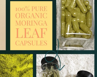 May include: Three glass jars with black lids containing green moringa leaf capsules and powder. The jars are labeled "100% PURE ORGANIC MORINGA LEAF CAPSULES" and "Moringa In The Raw".
