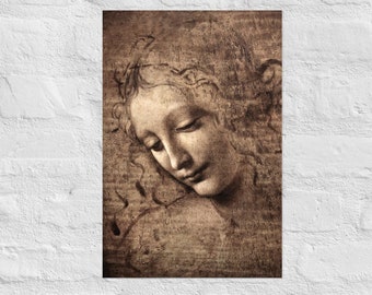 May include: A sepia-toned print of a classical drawing of a woman's face, with her head tilted downward. The artwork features soft shading and delicate lines, with a focus on the woman's serene expression and flowing hair. The print is mounted on a white brick wall.