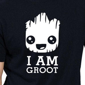 May include: Black t-shirt with a white graphic of a cartoon Groot from Guardians of the Galaxy. The text "I AM GROOT" is printed below the graphic.