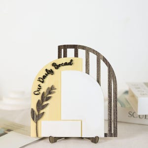 May include: A set of three ceramic mugs with a speckled, matte finish. The mugs are in shades of cream, light gray, and dark gray. Each mug has a simple, minimalist design and a rounded handle.