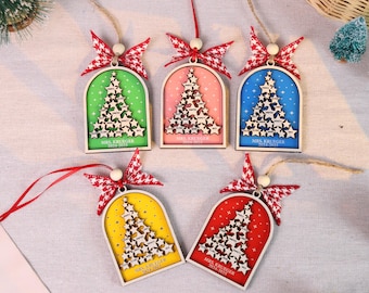 May include: A collection of five wooden Christmas tree ornaments. Each ornament features a colorful arched background, a star-shaped tree design, and a red and white bow. The text "MRS. KRUEGER 2023-2024" is visible on each ornament.