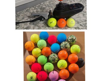 May include: A collection of colourful golf balls, including yellow, green, orange, red, blue and camouflage patterns. Some balls have the brand name "Volvik" printed on them.