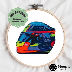 May include: A cross-stitch pattern of a colorful racing helmet with the words "Monster Energy" and "dubber" on it.