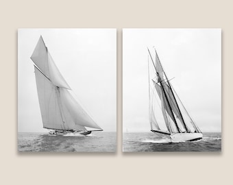 May include: Two black and white photographs of sailboats with their sails billowing in the wind. The sailboats are on the water and the sky is clear.