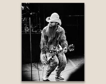 Billy Gibbons, ZZ Top performing on stage at a concert in 1981. Restored vintage black and white photo printed at museum quality.