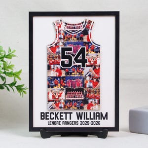 May include: A framed collage featuring a basketball jersey design with the number 54. The jersey is filled with multiple photos and set against a white background. The frame includes the name "BECKETT WILLIAM" and "LENORE RANGERS 2025-2026".