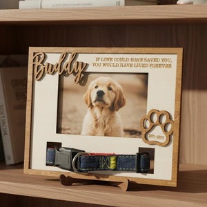 May include: Wooden picture frame with a photo of a golden retriever puppy. The frame includes the name "Buddy" and the text "IF LOVE COULD HAVE SAVED YOU, YOU WOULD HAVE LIVED FOREVER." A dog collar and paw print are also included.