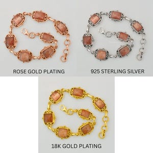 May include: Three bracelets featuring rectangular sunstone cabochons set in ornate metal frames. The top left is rose gold plating, the top right is 925 sterling silver, and the bottom is 18k gold plating. Each includes a lobster clasp and chain.