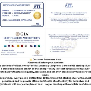 May include: A white informational document featuring two certificates of authenticity. The top section displays an STL certificate for 92.5% silver jewelry. The middle section shows a GIA certificate for natural gemstones. The bottom includes a customer awareness note.