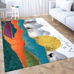 May include: Abstract landscape rug with a colorful design featuring a large yellow sun, mountains, trees, and birds. The rug has a white background with a subtle texture.