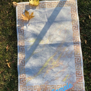 May include: A white rug with a brown Greek key border. The rug has a subtle, light-colored pattern and is lying on a bed of green grass. The text "Sample Etsy/Shop/RugStreet" is visible in the bottom right corner.