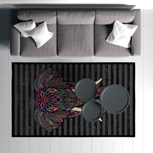May include: A black and white striped rug with a colorful elephant mandala design. Three round black side tables are placed on the rug.