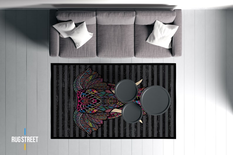 May include: A black and white striped rug with a colorful elephant mandala design. Three round black side tables are placed on the rug.