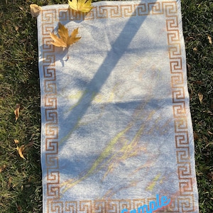 May include: A white rug with a brown Greek key border. The rug has a subtle, light-colored pattern and is lying on a bed of green grass. The text "Sample Etsy/Shop/RugStreet" is visible in the bottom right corner.