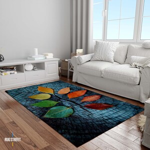 May include: A blue and brown rug with a wood grain pattern and colorful leaves. The leaves are in shades of red, orange, yellow, green, and blue.