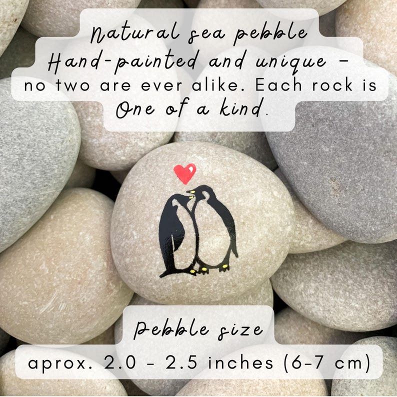 May include: Hand-painted natural sea pebble with a black penguin couple design and a red heart. The pebble is approximately 2.0 - 2.5 inches in size. The text on the image says "Natural sea pebble, Hand-painted and unique - no two are ever alike. Each rock is One of a kind."