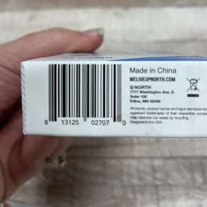 May include: A white box with a black barcode and text that reads "Made in China", "WELIVEUPNORTH.COM", "NORTH", "7777 Washington Ave. S", "Suite 108", "Edina, MN 55439", "All brands, product names and logos are trademarks or registered trademarks of their respective companies", "Help minimize our waste by recycling", and "Designed in the USA".