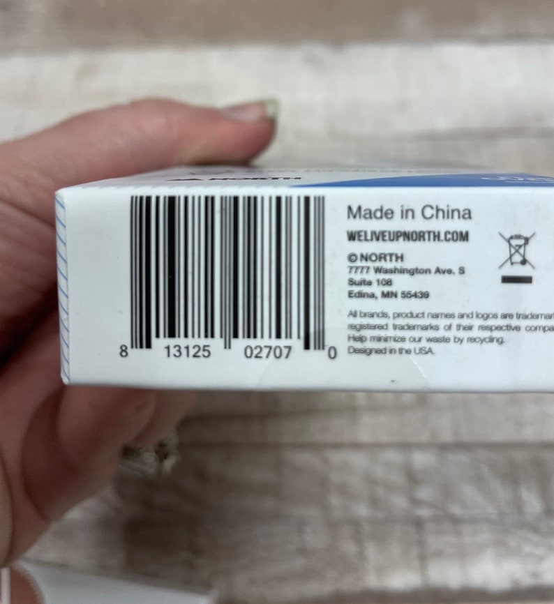 May include: A white box with a black barcode and text that reads "Made in China", "WELIVEUPNORTH.COM", "NORTH", "7777 Washington Ave. S", "Suite 108", "Edina, MN 55439", "All brands, product names and logos are trademarks or registered trademarks of their respective companies", "Help minimize our waste by recycling", and "Designed in the USA".