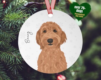 May include: A round white Christmas ornament with a brown and white doodle dog illustration. The dog's name, "Benny", is written in cursive on the ornament. The ornament has a white background with a snowflake pattern.