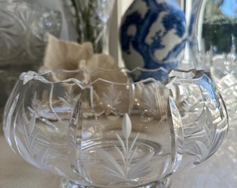May include: A clear glass bowl with an etched floral design. The bowl has a scalloped rim and a wide base.