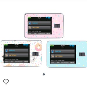 May include: Three different insulin pump designs with colorful donut and sprinkle patterns. The pumps have a digital display with the time, date, and insulin levels. The buttons read "BOLUS" and "OPTIONS".