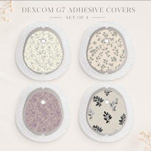 May include: A set of four Dexcom G7 adhesive covers featuring distinct patterns. The top left has a small floral print, the top right has a leaf pattern, the bottom left has a purple floral design, and the bottom right has a black leaf print.