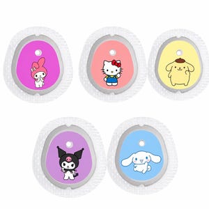 May include: Five character-themed accessories. Each features a different cartoon character on a coloured oval, including Hello Kitty, My Melody, and others. The ovals are set within a white, textured border.