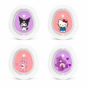 May include: Four white, oval accessories with textured edges. Each features a different cartoon character: a black and white character, Hello Kitty, a pink Care Bear, and a purple Care Bear. The backgrounds are pink and purple.