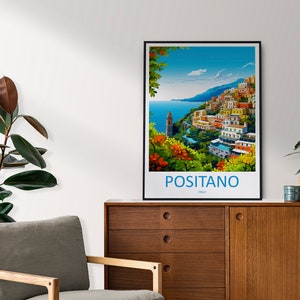 Puede incluir: Un p&oacute;ster colorido con marco negro que representa una ciudad costera con edificios coloridos en una ladera. El texto "POSITANO ITALIA" est&aacute; en la parte inferior del p&oacute;ster.