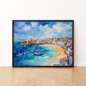 May include: Watercolor painting of a coastal town with a sandy beach, boats, and a clear blue sea. The artwork is framed in a black border. The sky is a bright blue with fluffy white clouds. Buildings line the shore.
