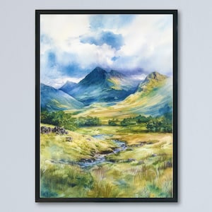 May include: Watercolor painting of a mountain landscape with a stream. The artwork features green and yellow grassy fields, lush green trees, and majestic blue mountains under a cloudy sky. The painting is framed in a black frame.